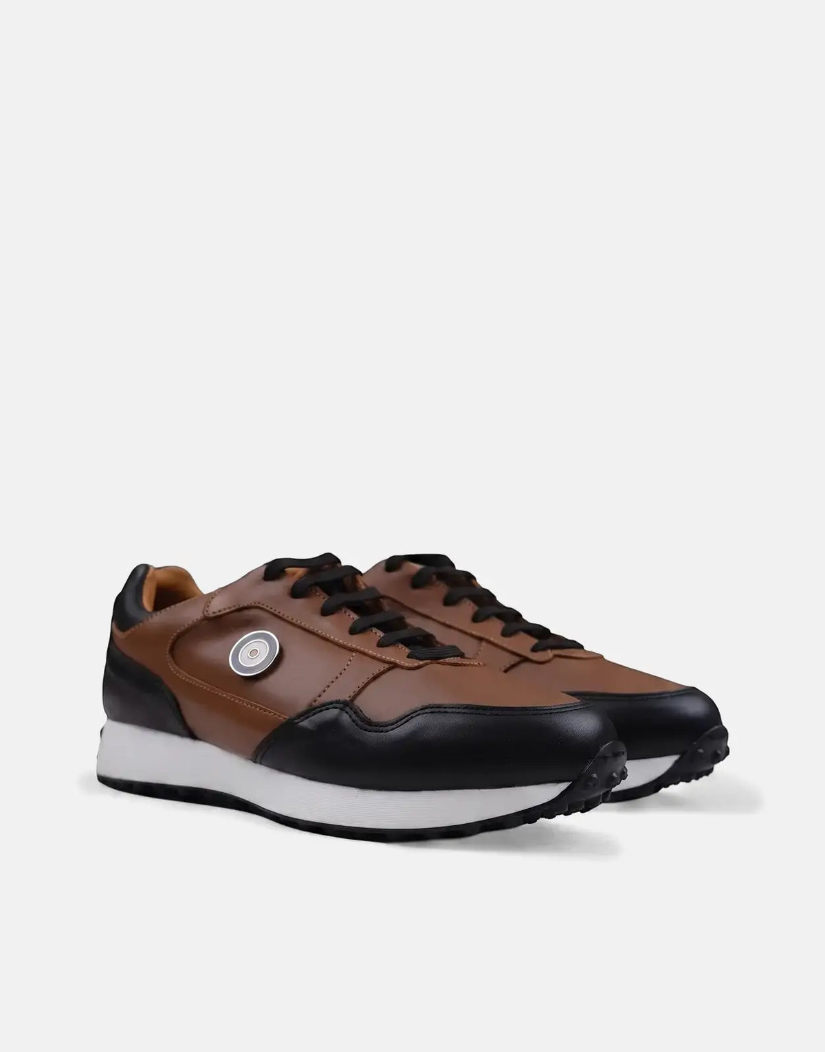 A pair of Ben Sherman Arthur sneakers in tan and black leather, featuring a white sole and black laces, positioned on a
