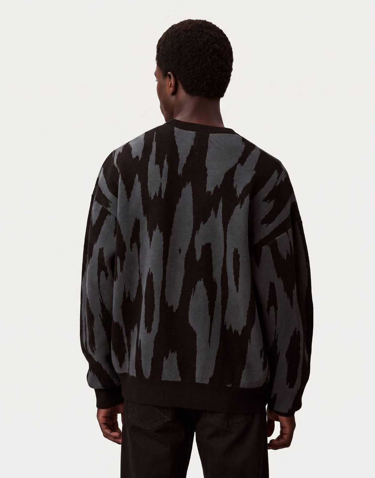 Men's Calvin Klein Abstract Jacquard Sweatshirt in black and grey with a unique patterned knit, shown from the back view.