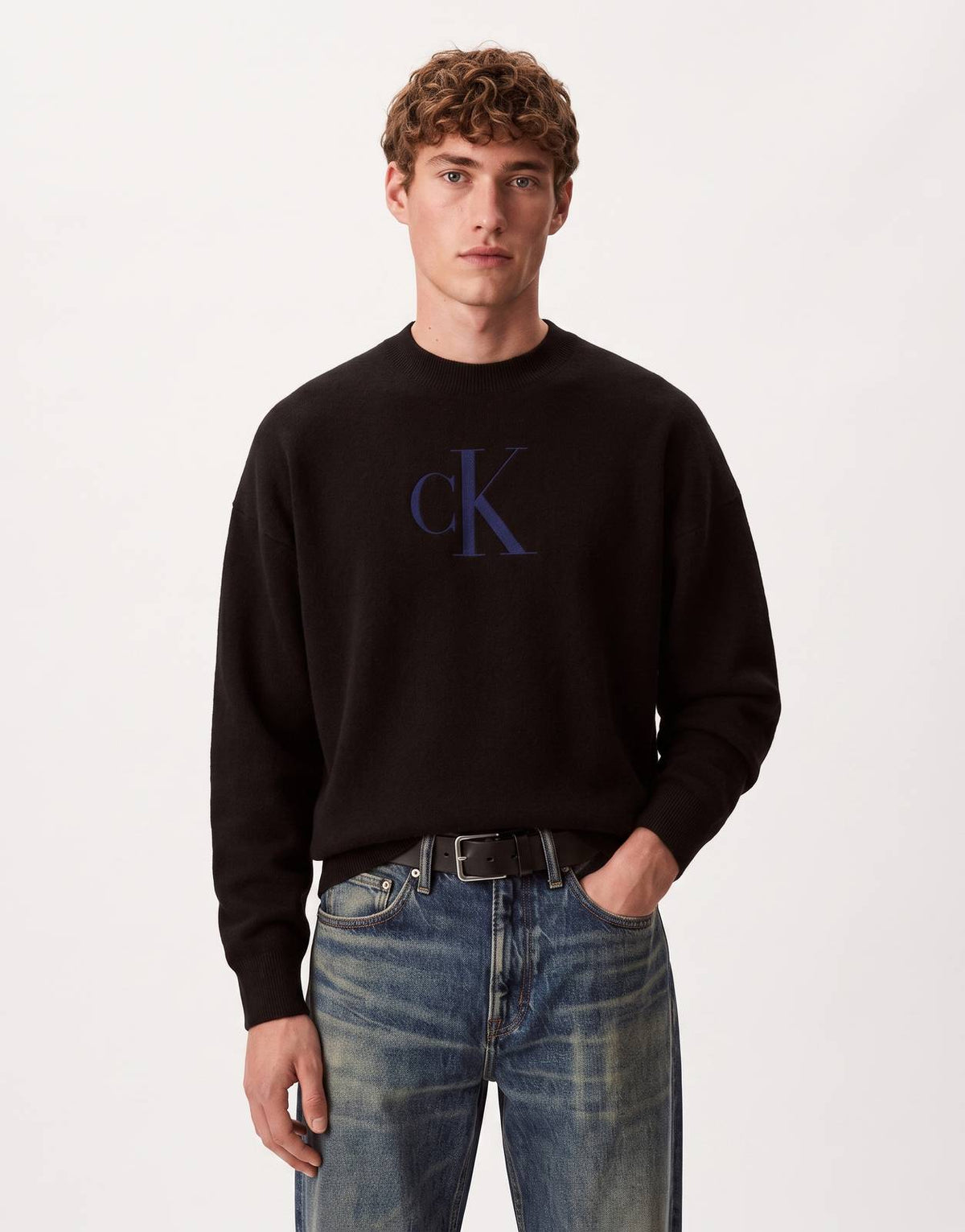 Calvin Klein Cashmere 3D Logo Sweatshirt in black with a prominent blue logo, shown on a male model from the front.