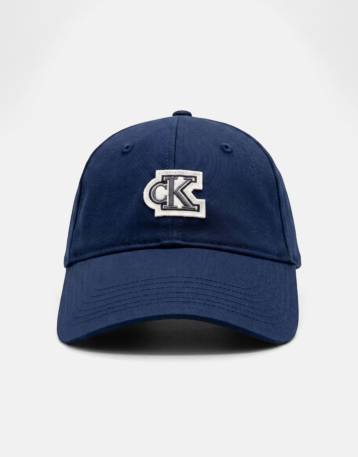 Calvin Klein Cotton Twill Small Felt Navy Patch Cap with an embroidered CK logo on the front