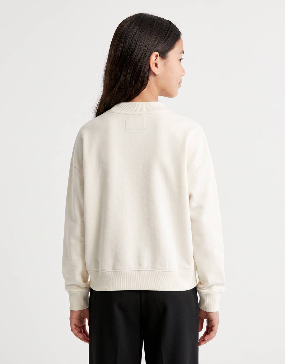 Calvin Klein Kids Script Logo Sweatshirt in off-white, shown from the back on a model, featuring a comfortable crew neck and