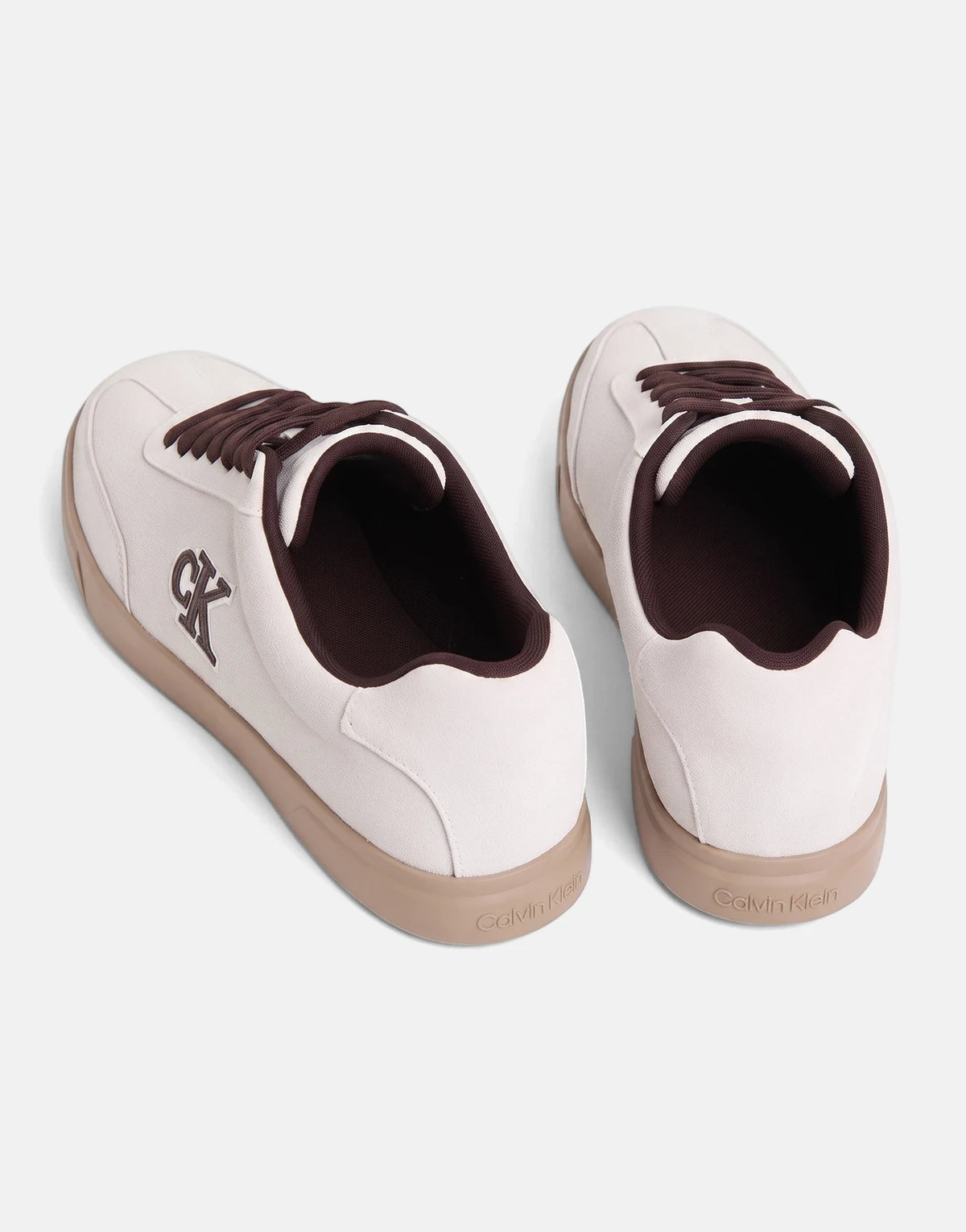A pair of Calvin Klein Low Prof White Multi Cupsole sneakers with brown laces and soles, viewed from above.