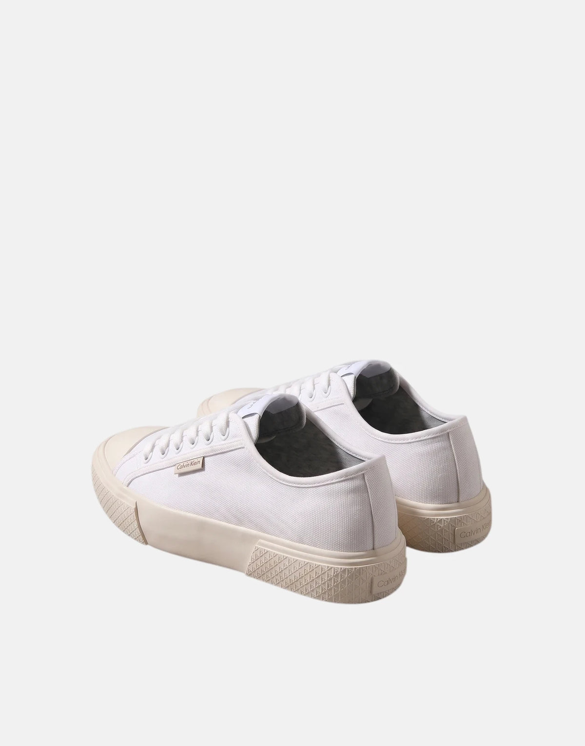 Calvin Klein Vulc Low Laceup White Canvas sneakers, presented in a rear three-quarter view on a studio background.