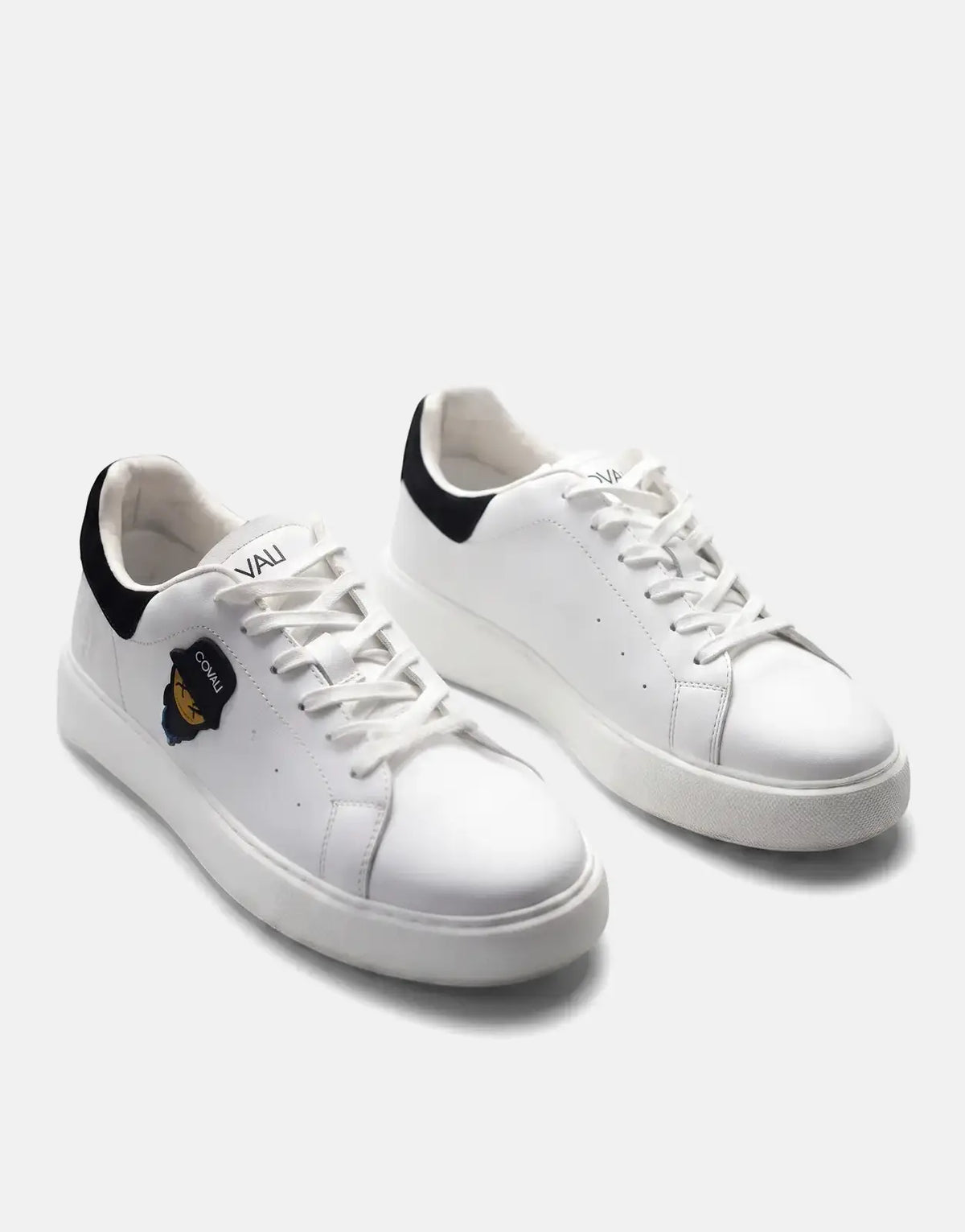 Pair of white Covali Tipo sneakers with black heel tabs and a small brand emblem displayed on a clean white background.