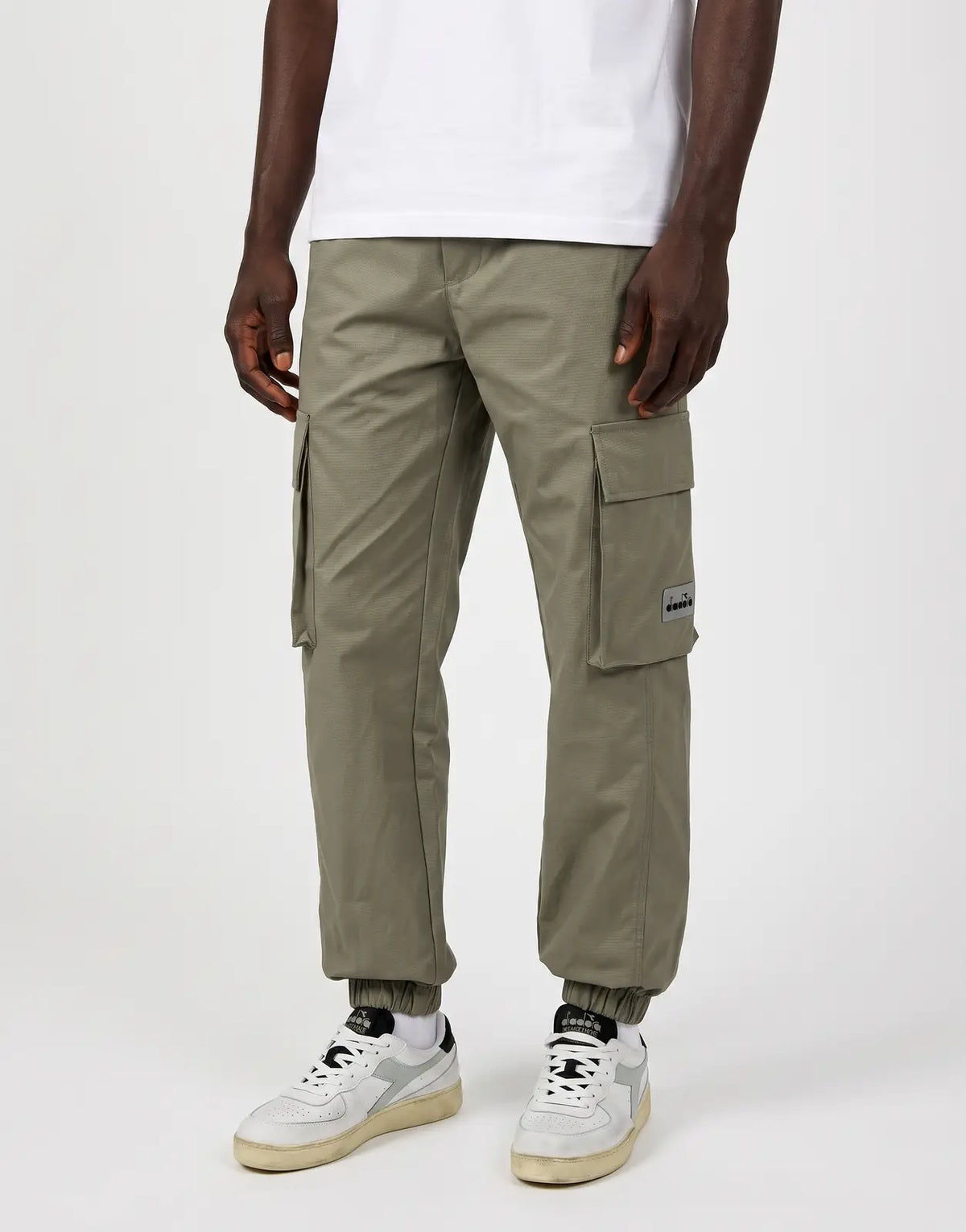 Diadora Marzio Grey Pants for men, cargo style with elasticated cuffs, featuring a subtle textured weave, shown worn by a