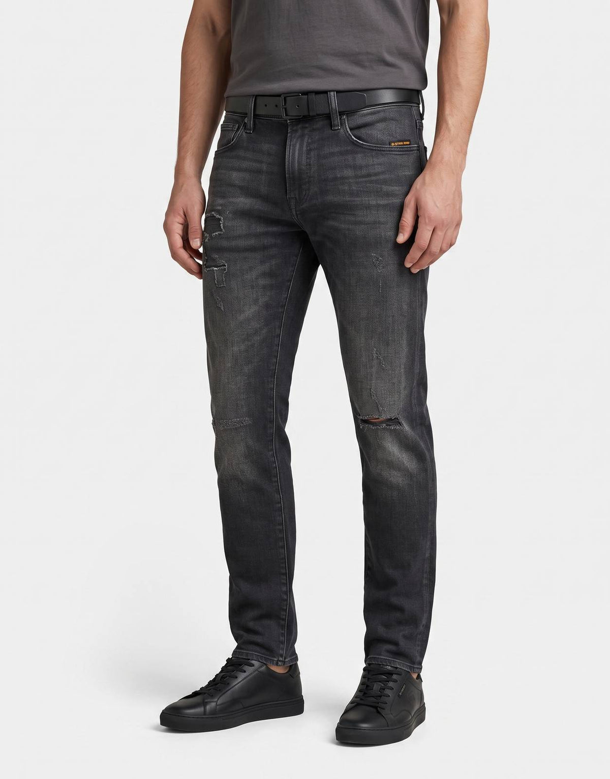 G-Star RAW 3301 Slim Worn in Ripped Black Jeans laid flat, showcasing the distressed details and dark wash.