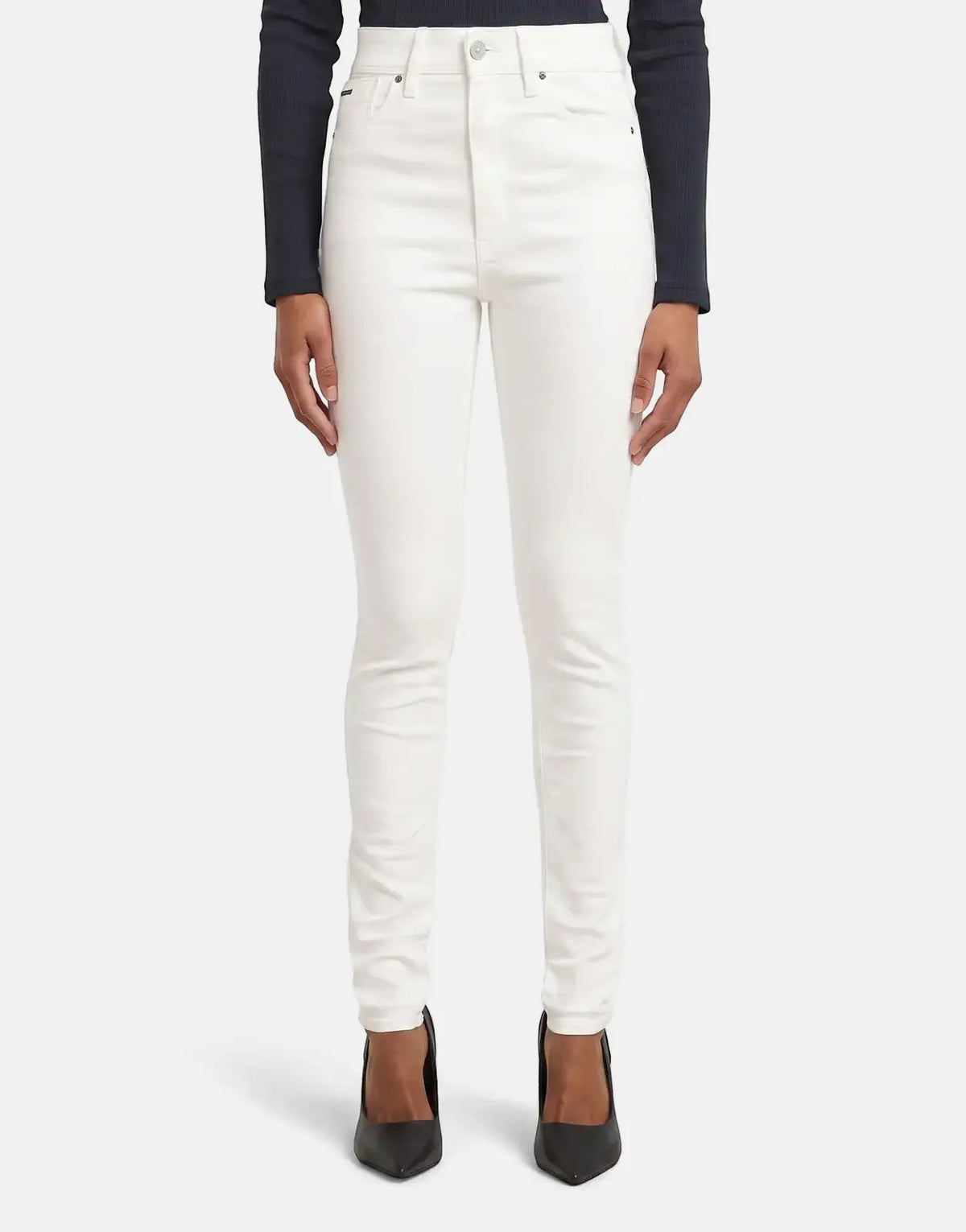 Full length view of white G-Star RAW Kafey Ultra High Skinny Rinsed Jeans worn by a model with black heels.