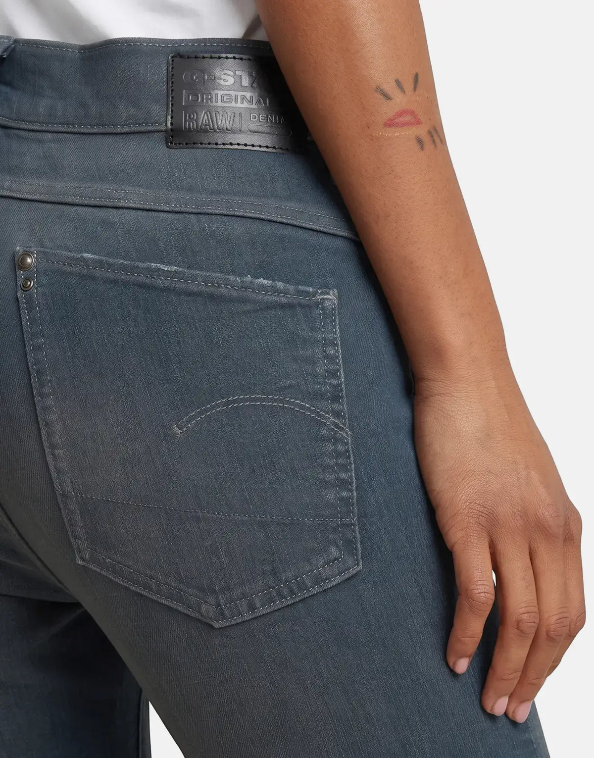 Close-up of G-Star RAW Lhana Skinny Worn in Smokey Night Jeans, dark blue-grey, showcasing the back pocket detail and a