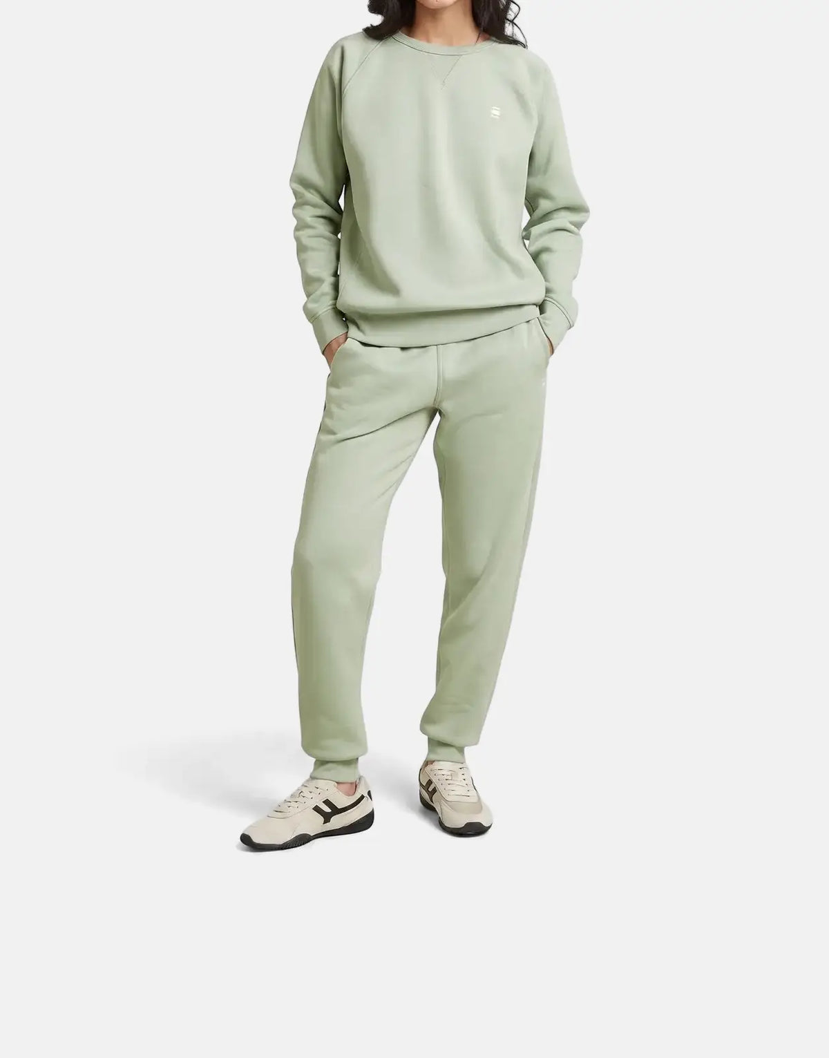Full-body shot of a model wearing a G-Star RAW Premium Core 2.0 pale green sweatshirt and matching sweatpants.