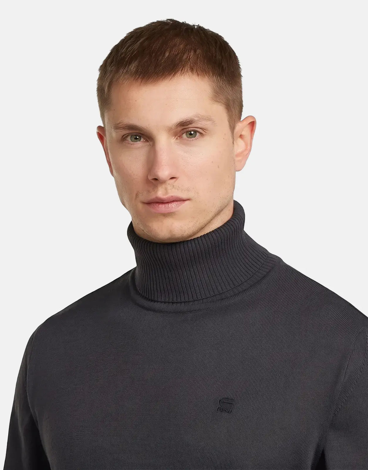 A male model wearing a dark grey G-Star RAW Regular Fit Asfalt Sweatshirt with a ribbed turtleneck collar.