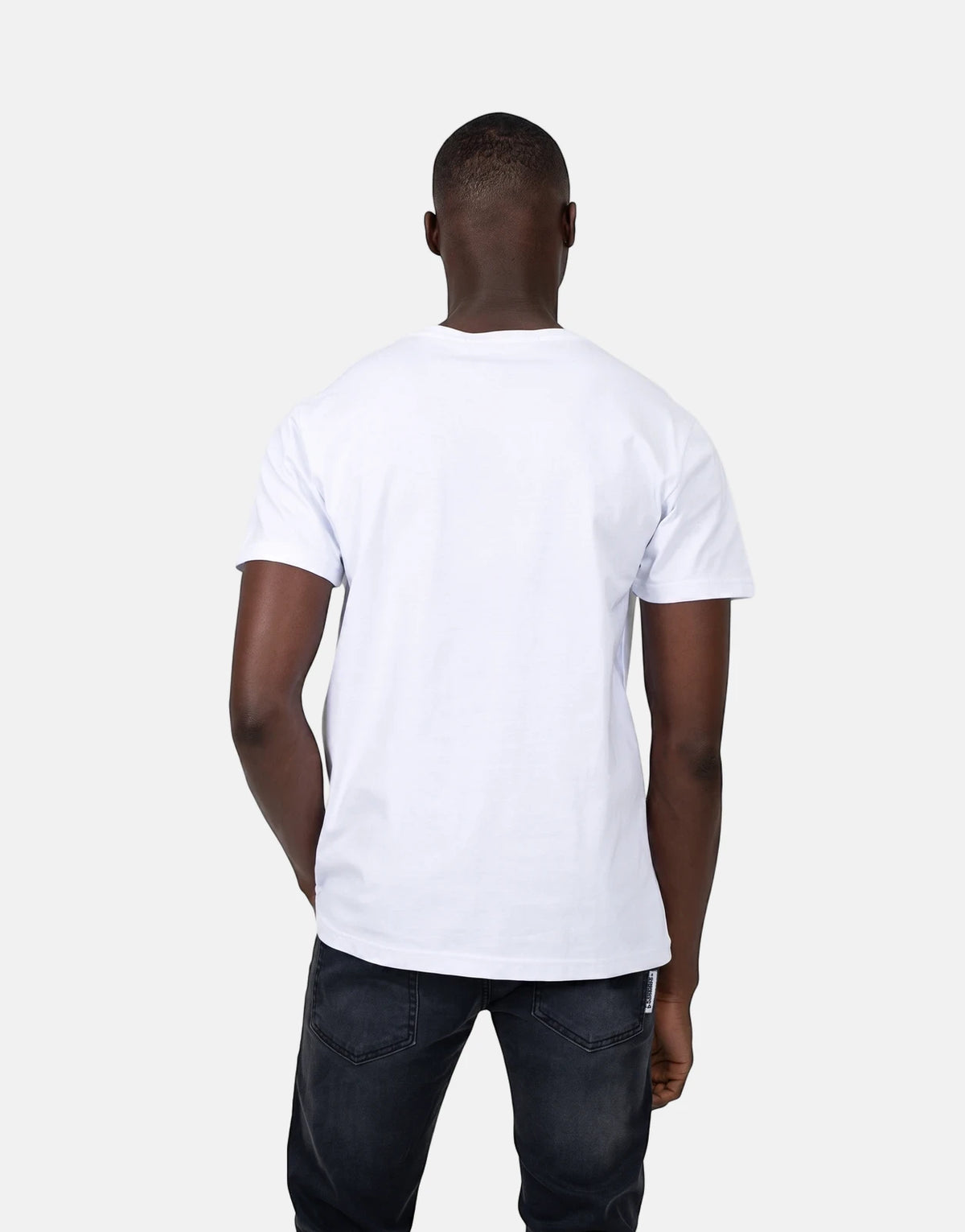Les Hommes Glitter Logo White T-Shirt on a man, viewed from the back, wearing dark jeans.