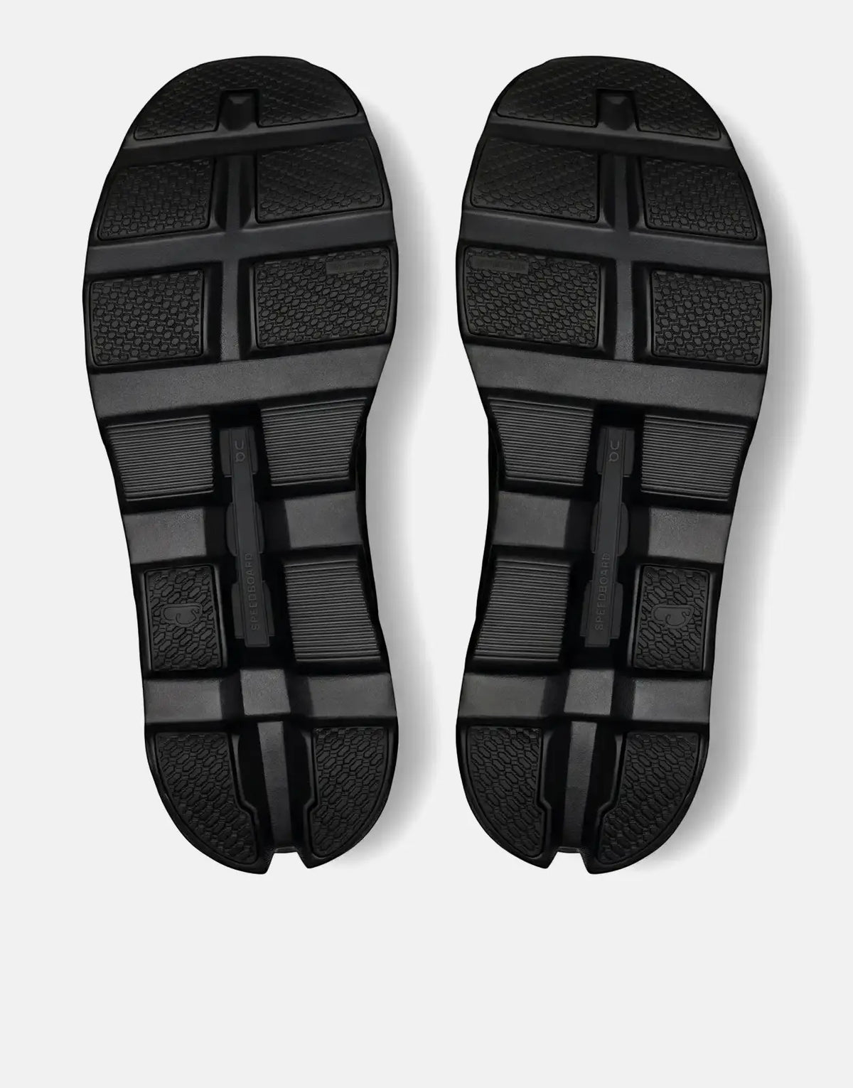 Bottom view of two black On Men's Cloudmonster Void Black sneakers, showcasing their textured soles and branding.
