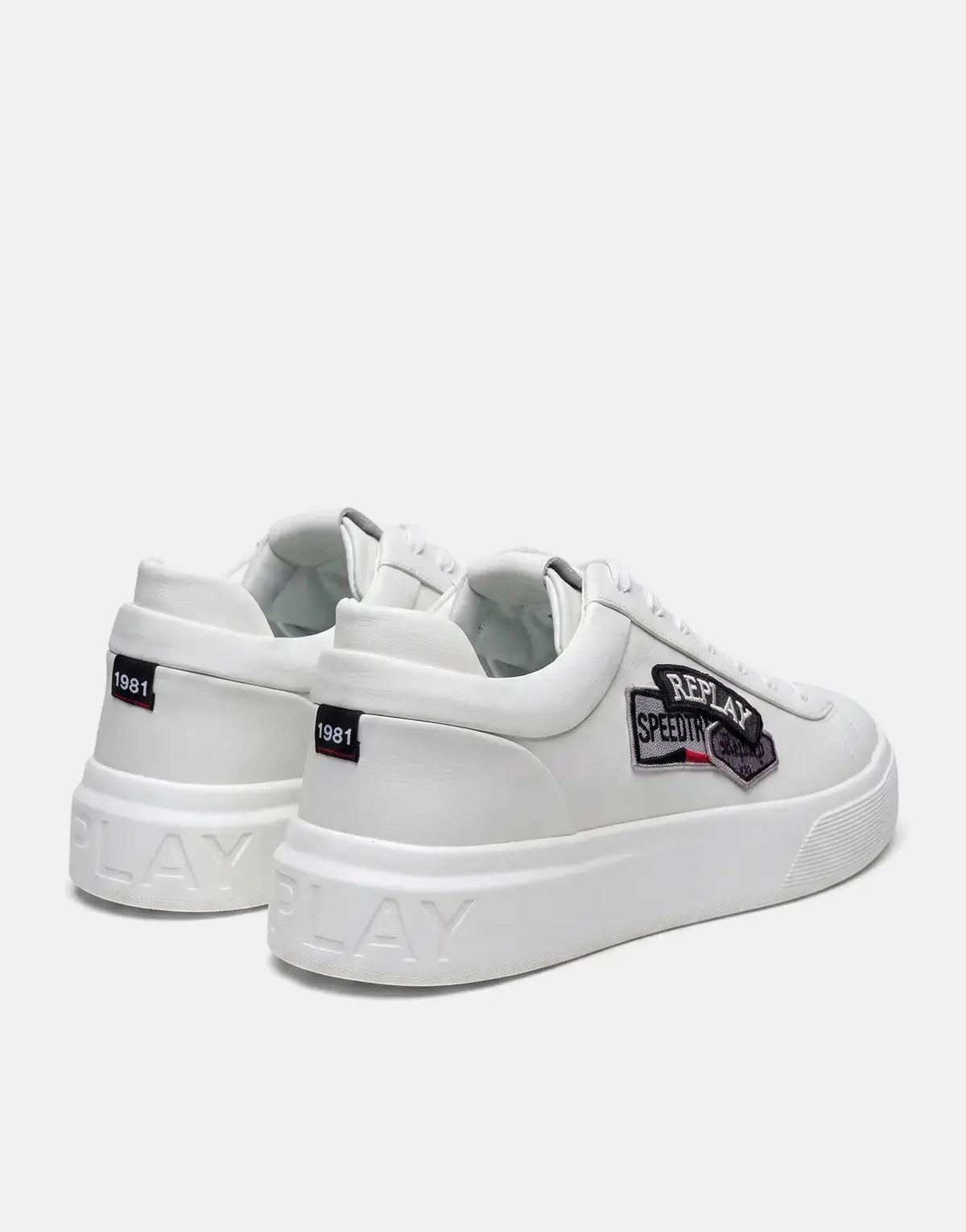 A pair of white Replay Notting Badges sneakers are shown from a rear-quarter view, highlighting the side patches and thick