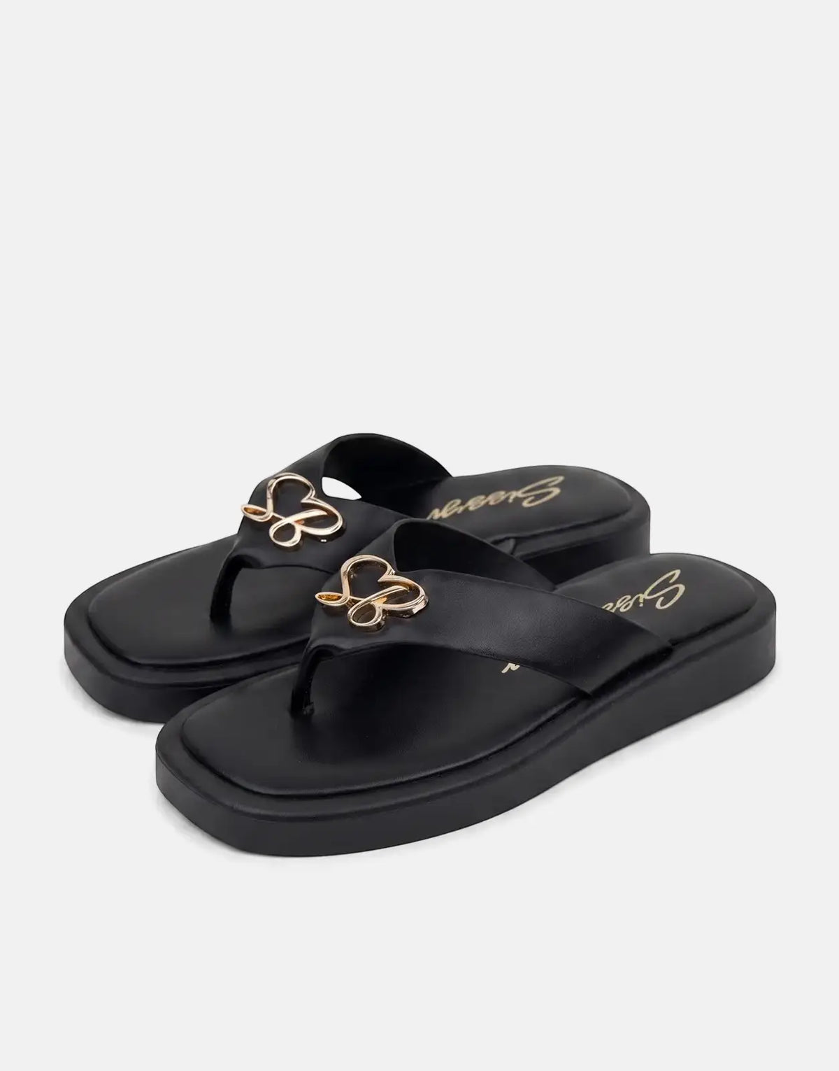 A pair of Sissy Boy Mimi black thong sandals with platform soles and gold heart-shaped embellishments on the straps, viewed