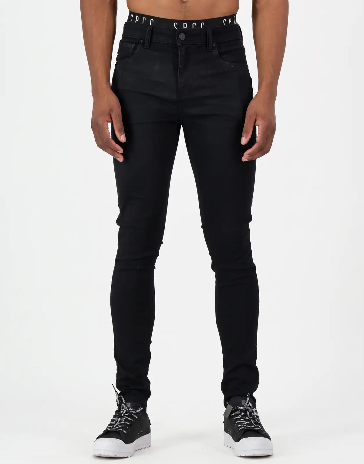 Black slim-fit SPCC Eclipse Jeans for men, featuring a visible branded waistband and sneakers, photographed on a model.