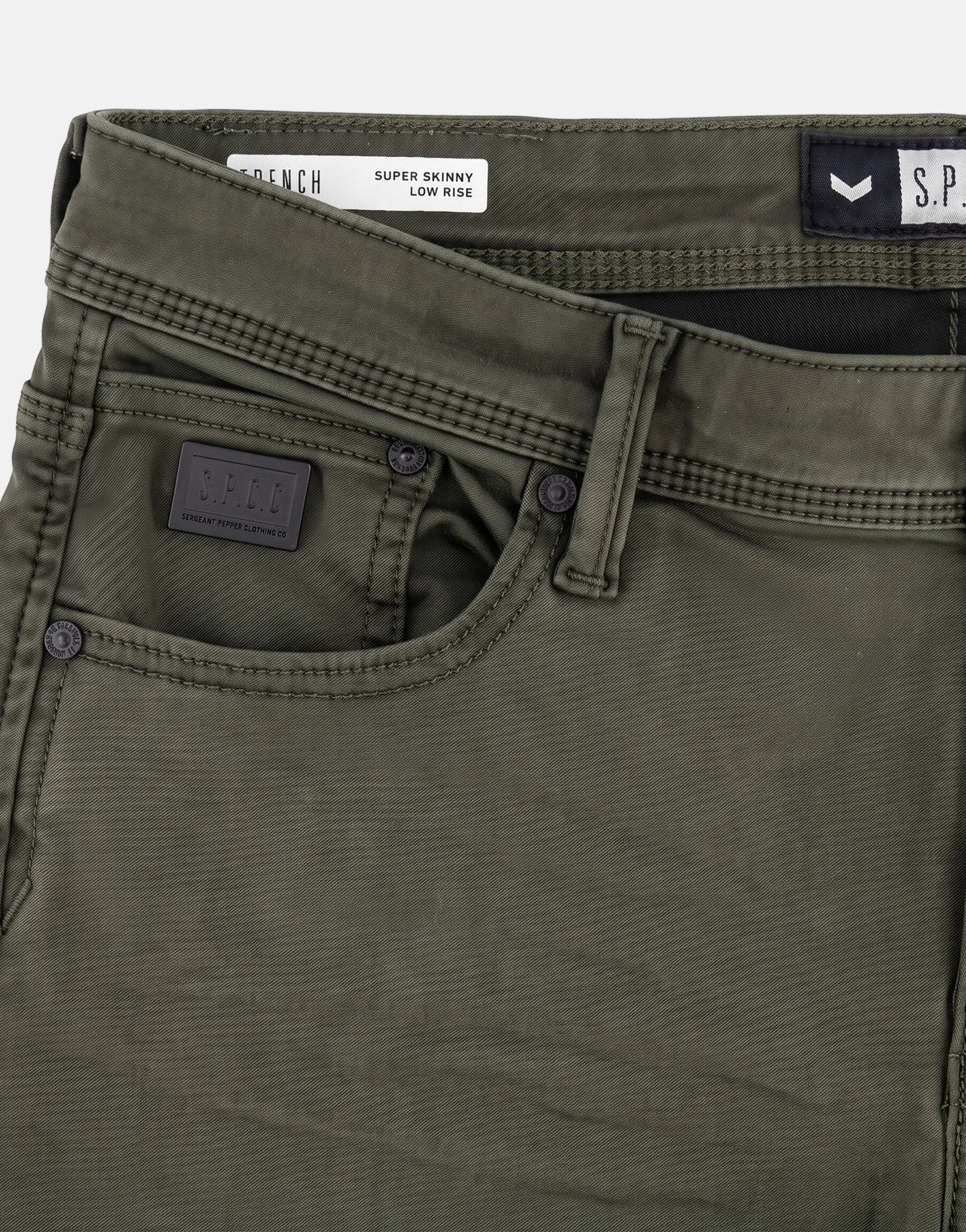 Close-up of SPCC Rodan Redrafted Fatigue Jeans, showing the dark green fabric, front pockets, and branded labels.