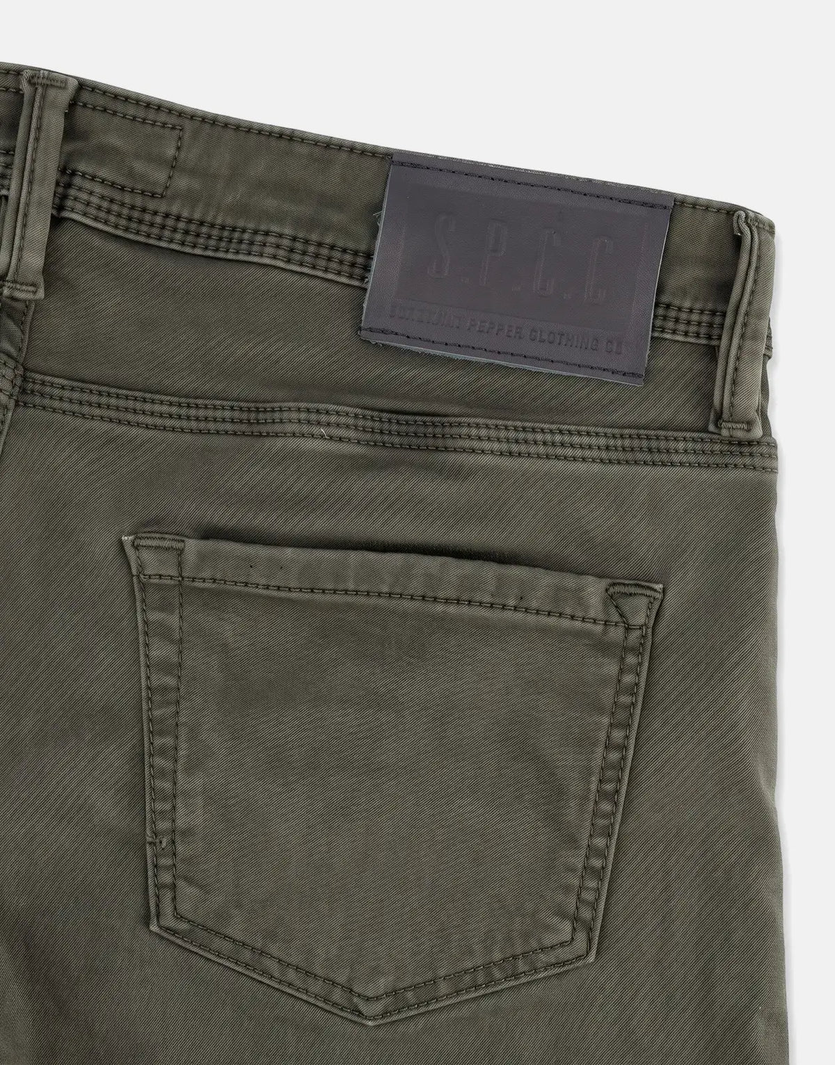 SPCC Rodan Redrafted Fatigue Jeans, close-up of the upper back with a black leather brand patch and pocket detail.