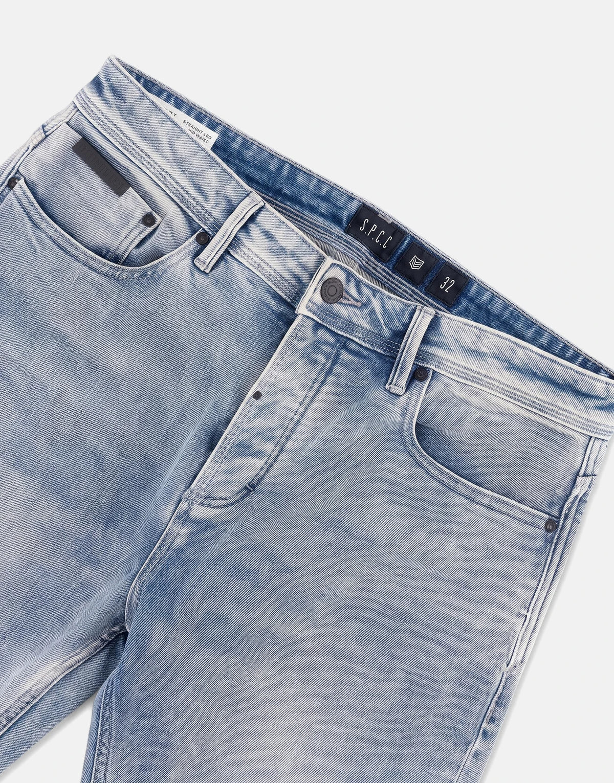 Close-up front view of men's SPCC Subzero Bleach Jeans in light blue washed denim, showing pockets and waistband details.
