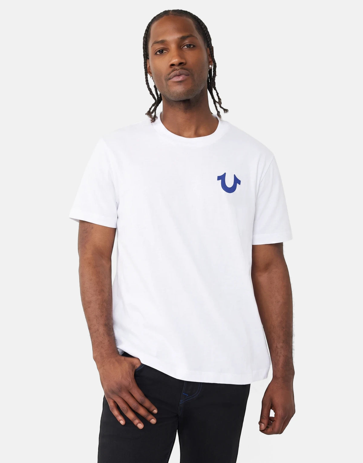 Men's white True Religion TR Rect T-shirt with a blue horseshoe logo on the chest, worn by a model with braided hair and