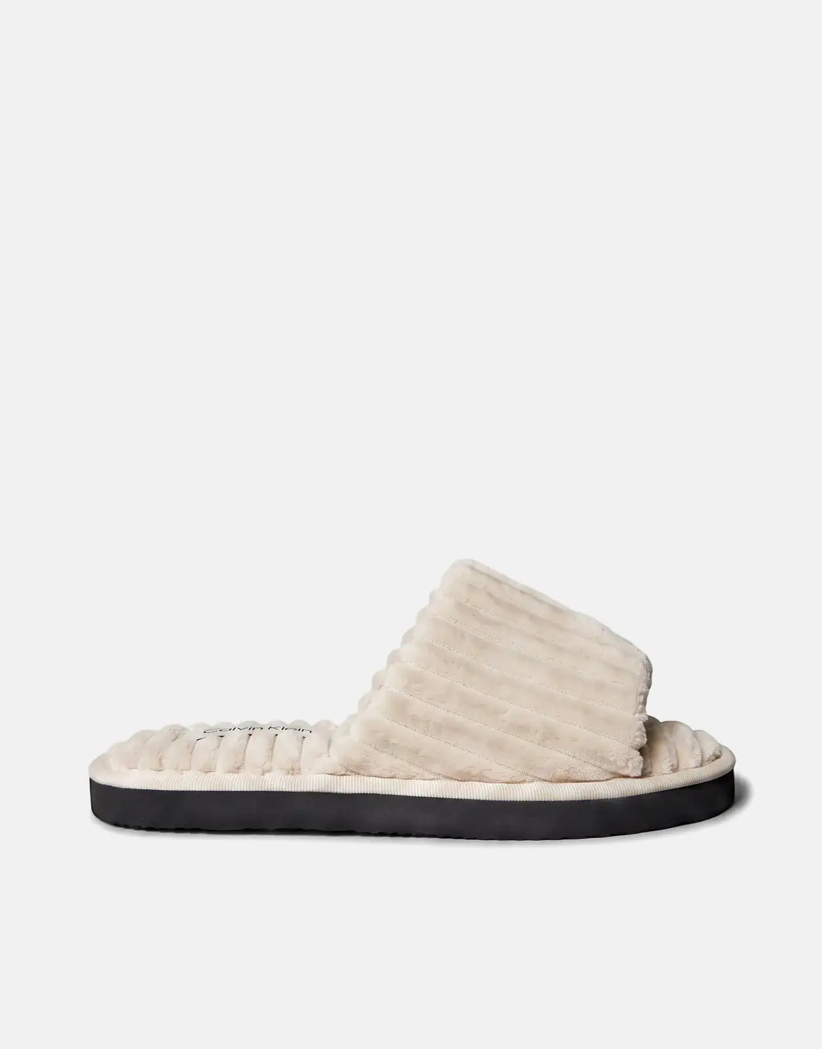 Calvin Klein cream corduroy slipper, presented in a comfortable side profile view for indoor wear.