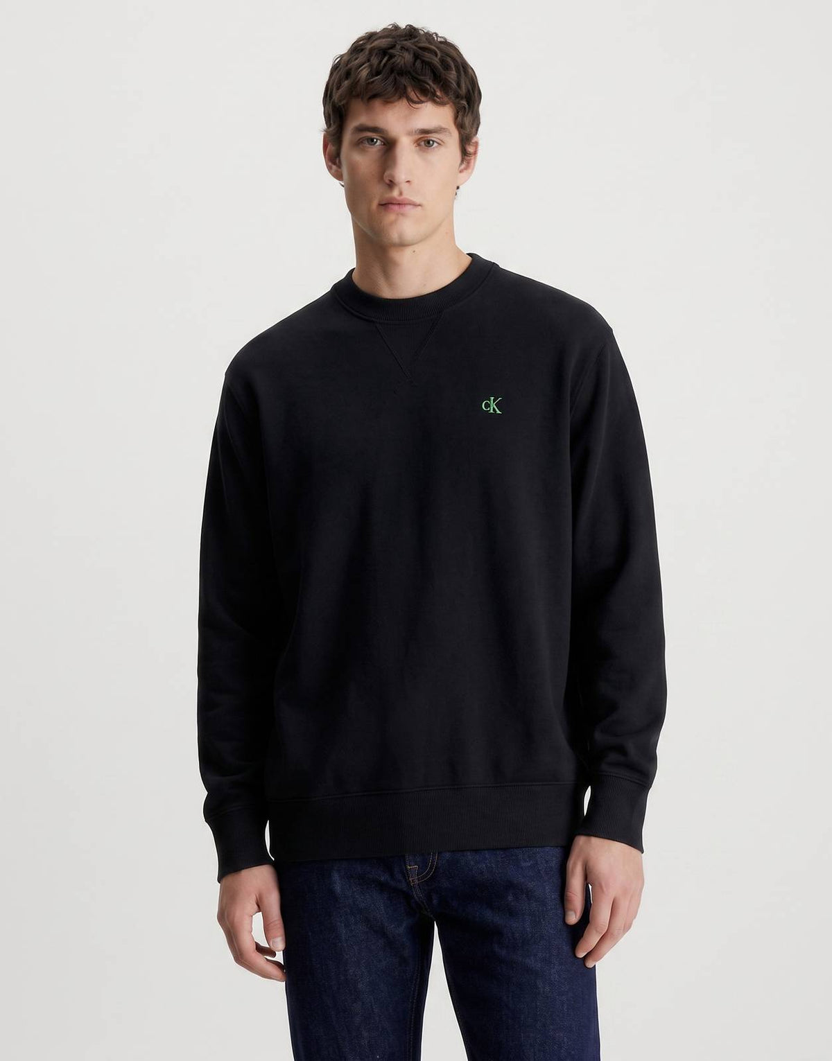 Men's black Calvin Klein EZ Sweatshirt with a crewneck, featuring a small green 'ck' logo on the chest.