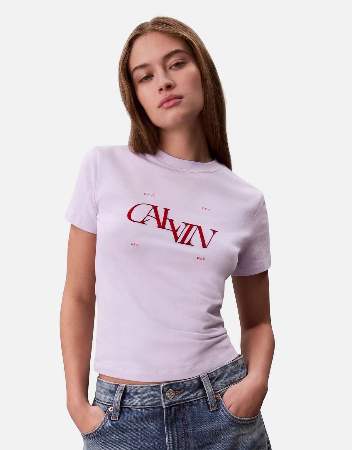 Calvin Klein Seasonal Graphic Slim Lilac T-Shirt for women, shown on a model with short sleeves and bold red graphic