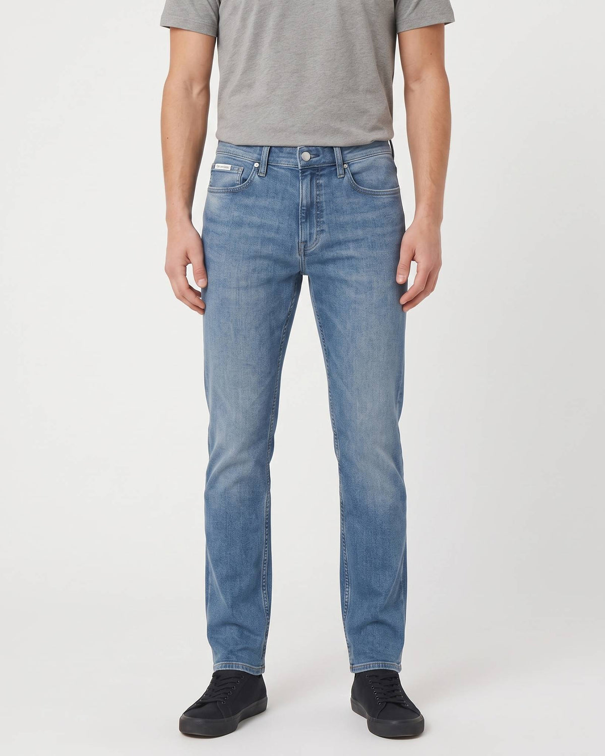 Calvin Klein Slim Faded Clearwater Denim Medium Jeans, front view, in a medium blue wash with distressed detailing.