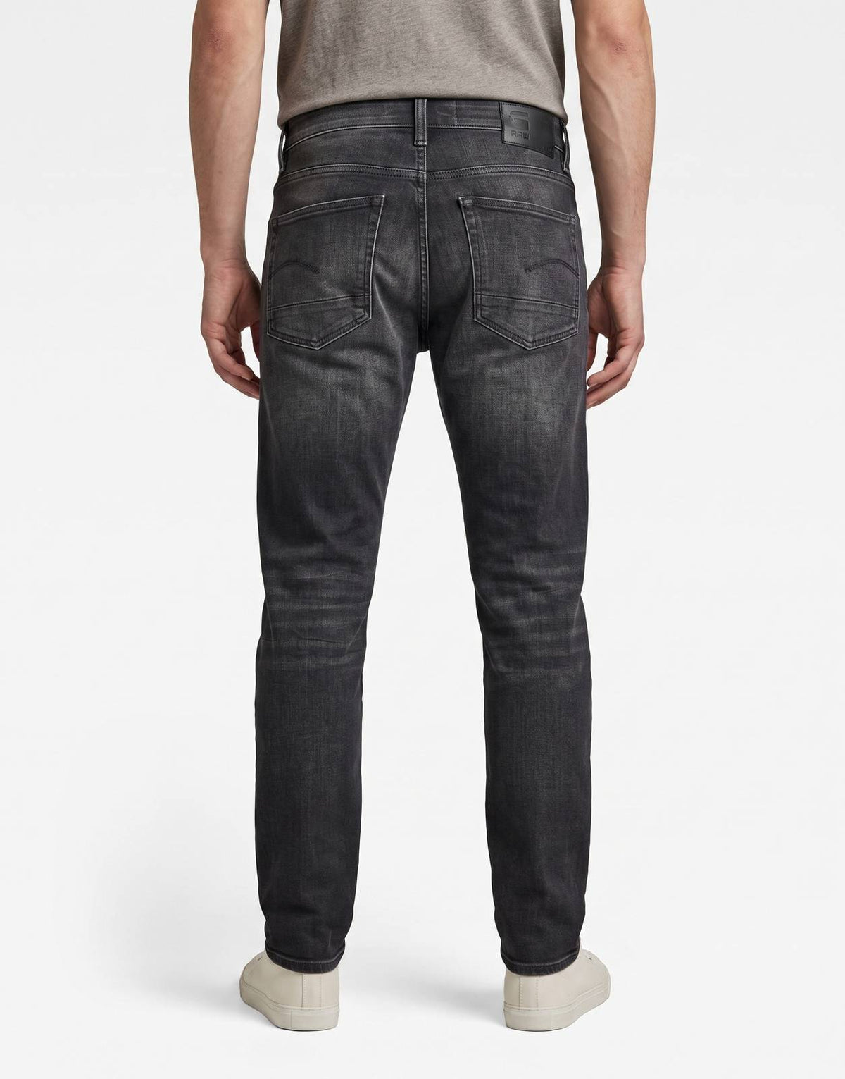 G-Star RAW 3301 Slim Worn in Ripped Black Jeans, photographed from the back, highlighting the faded denim and classic pocket