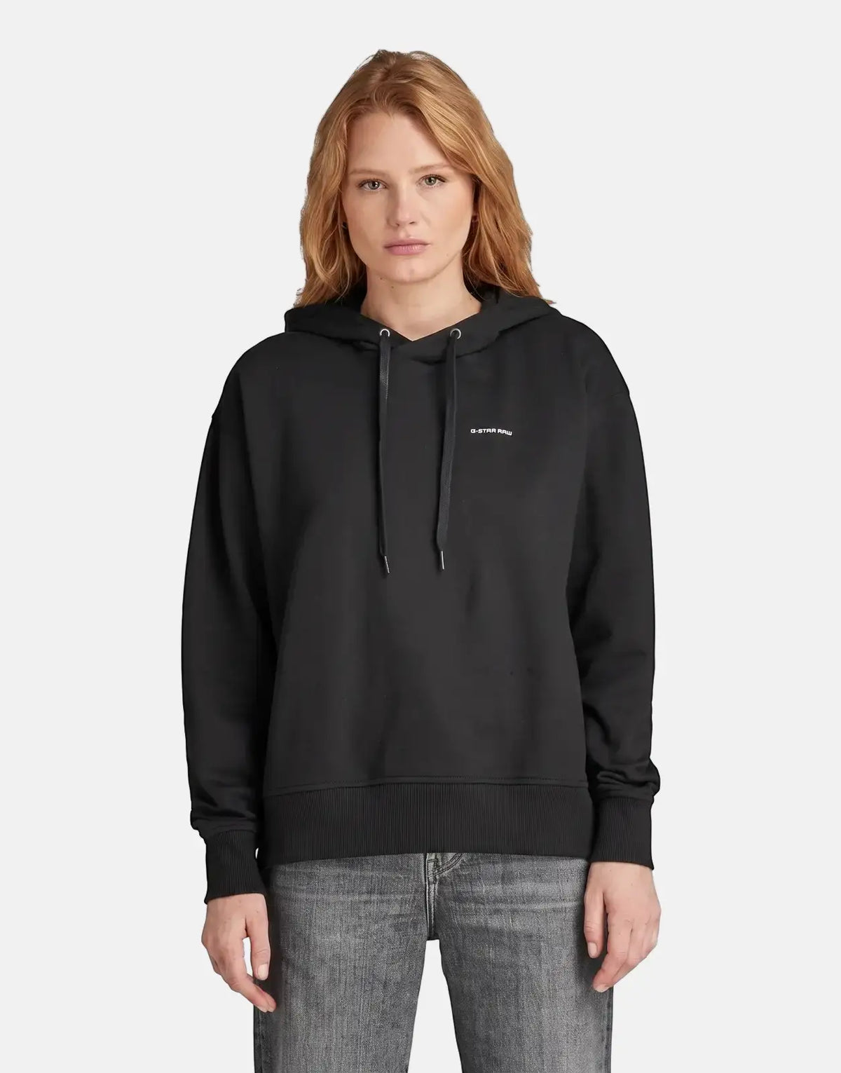 G-Star RAW Graphic Core Hood Dk Black worn by a woman, front view. The black hoodie features a white G-Star RAW logo on the