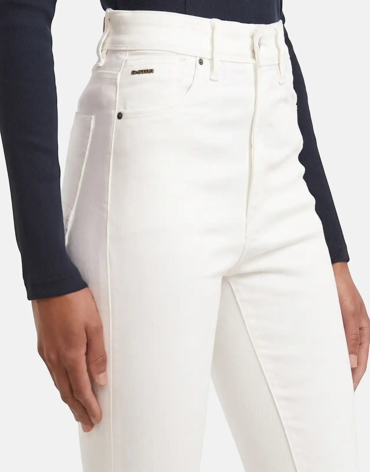 Close-up of a model wearing white G-Star RAW Kafey Ultra High Skinny Rinsed Jeans, showcasing the high-rise fit and denim