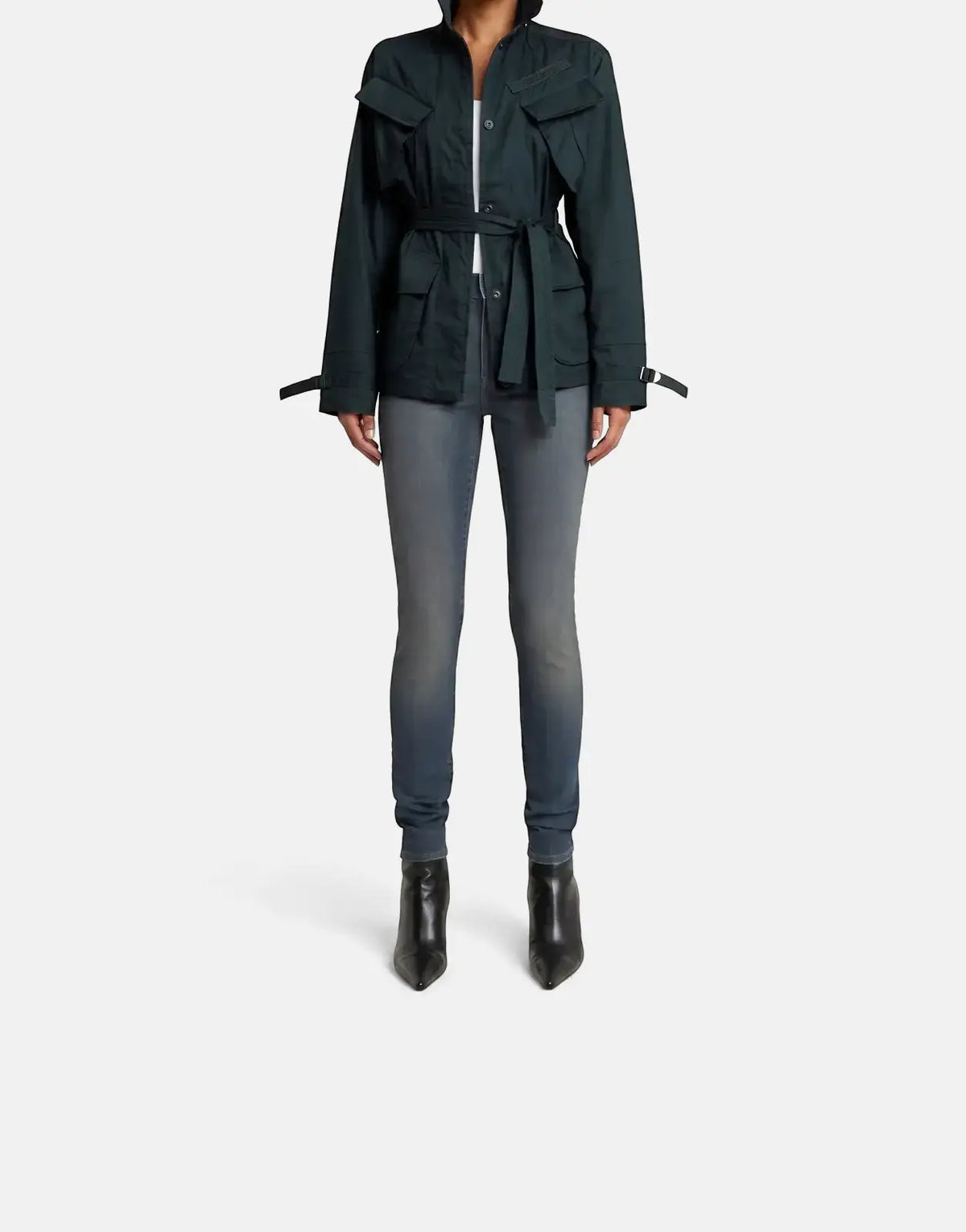 Model wearing G-Star RAW Lhana Skinny Worn in Smokey Night Jeans paired with a dark green belted jacket and black ankle