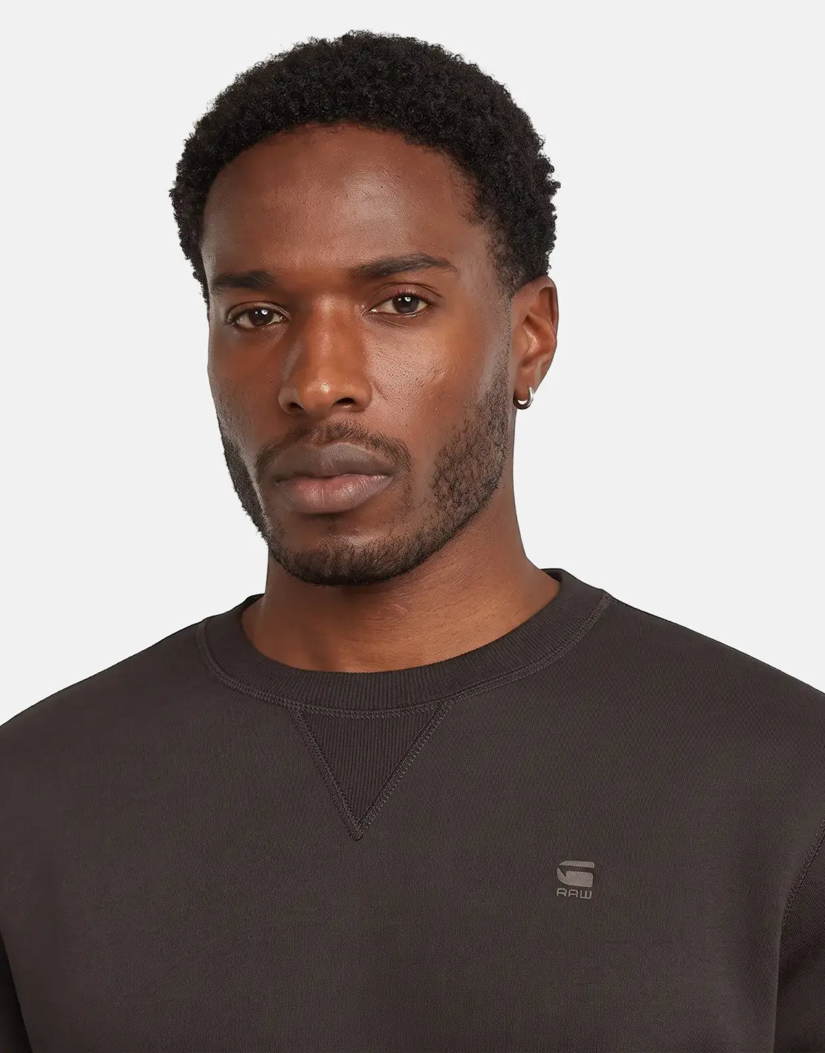 Dark brown G-Star RAW Premium Core Ganache Sweatshirt, a classic crewneck, modeled by a Black man with a beard.
