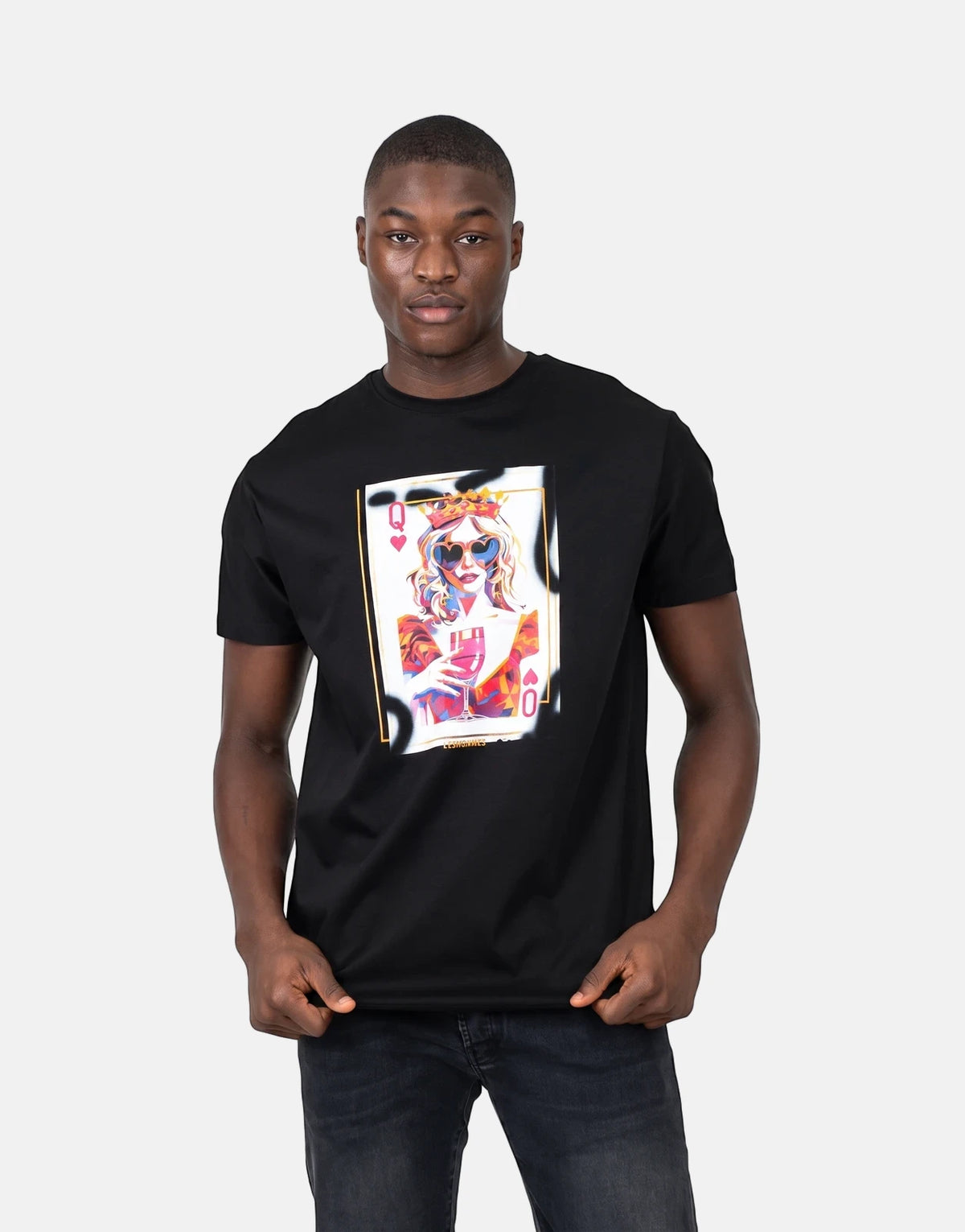 Les Hommes Queen Of Hearts Black T-Shirt on a male model, featuring a vibrant playing card graphic. Front view.