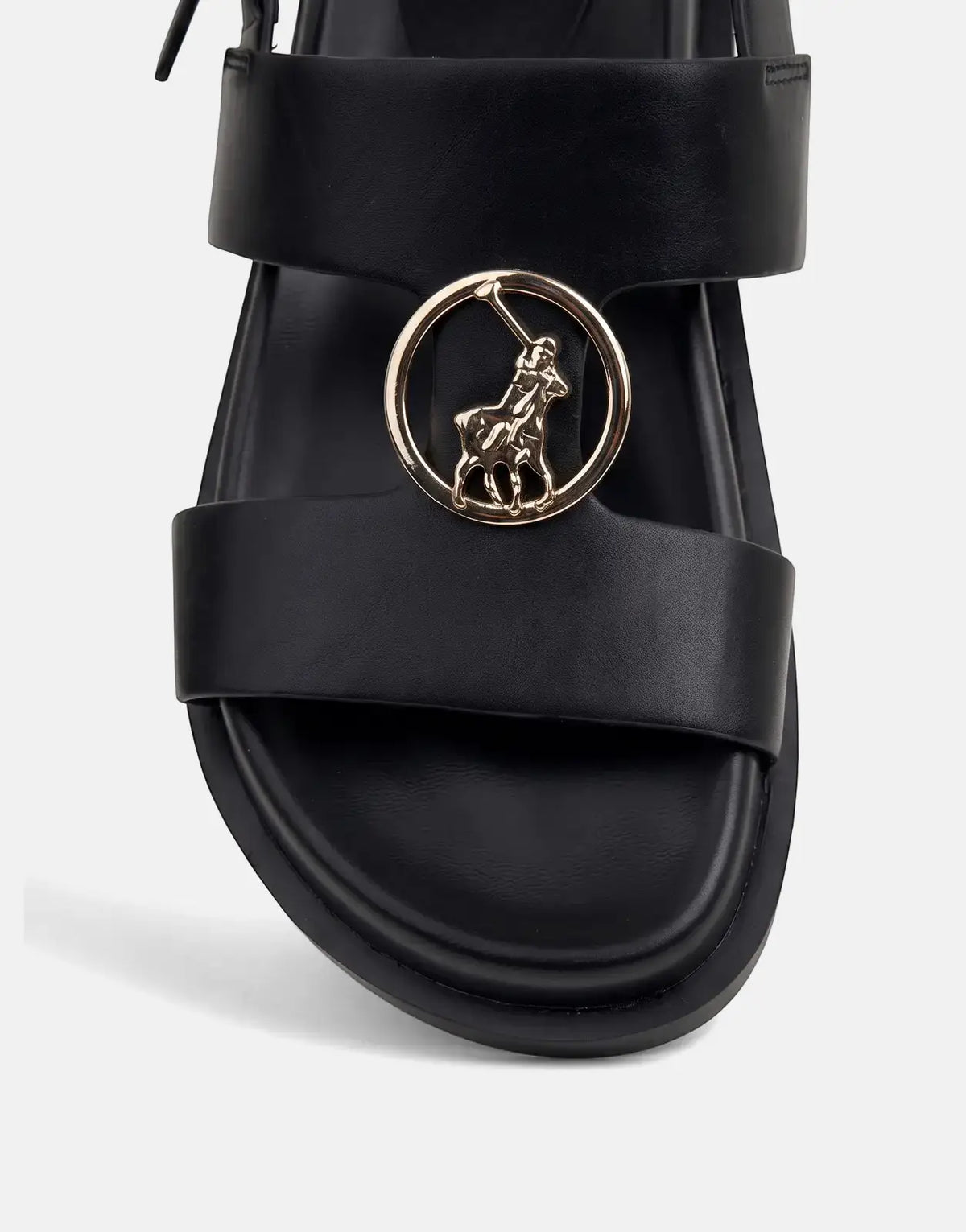 Close-up of a black leather Polo Moulded New Trim sandal, featuring a prominent gold Polo Ralph Lauren emblem on the strap.
