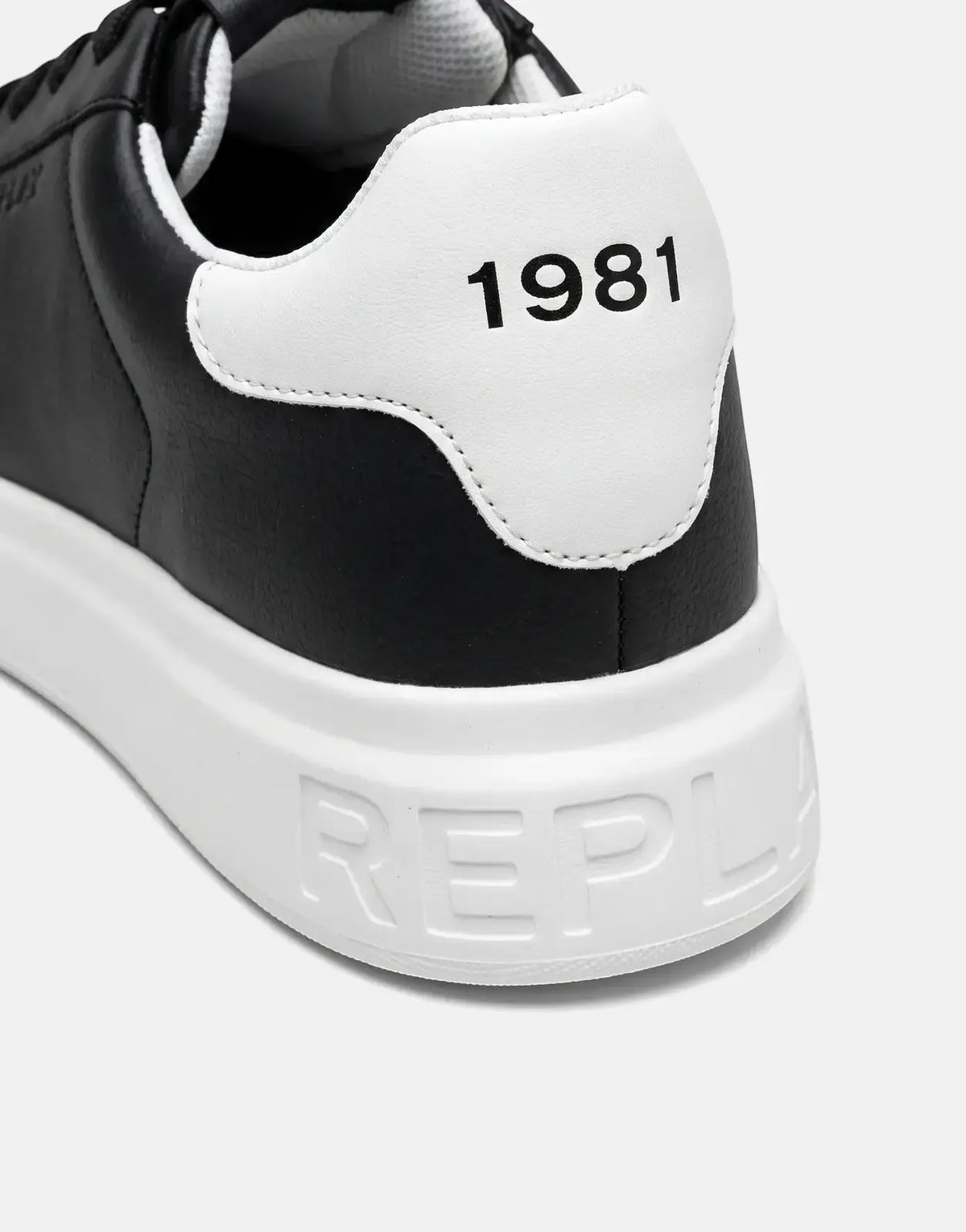 Close-up angled view of a black and white Replay Notting Medium Sneaker, featuring '1981' on the heel and 'REPLAY' on the