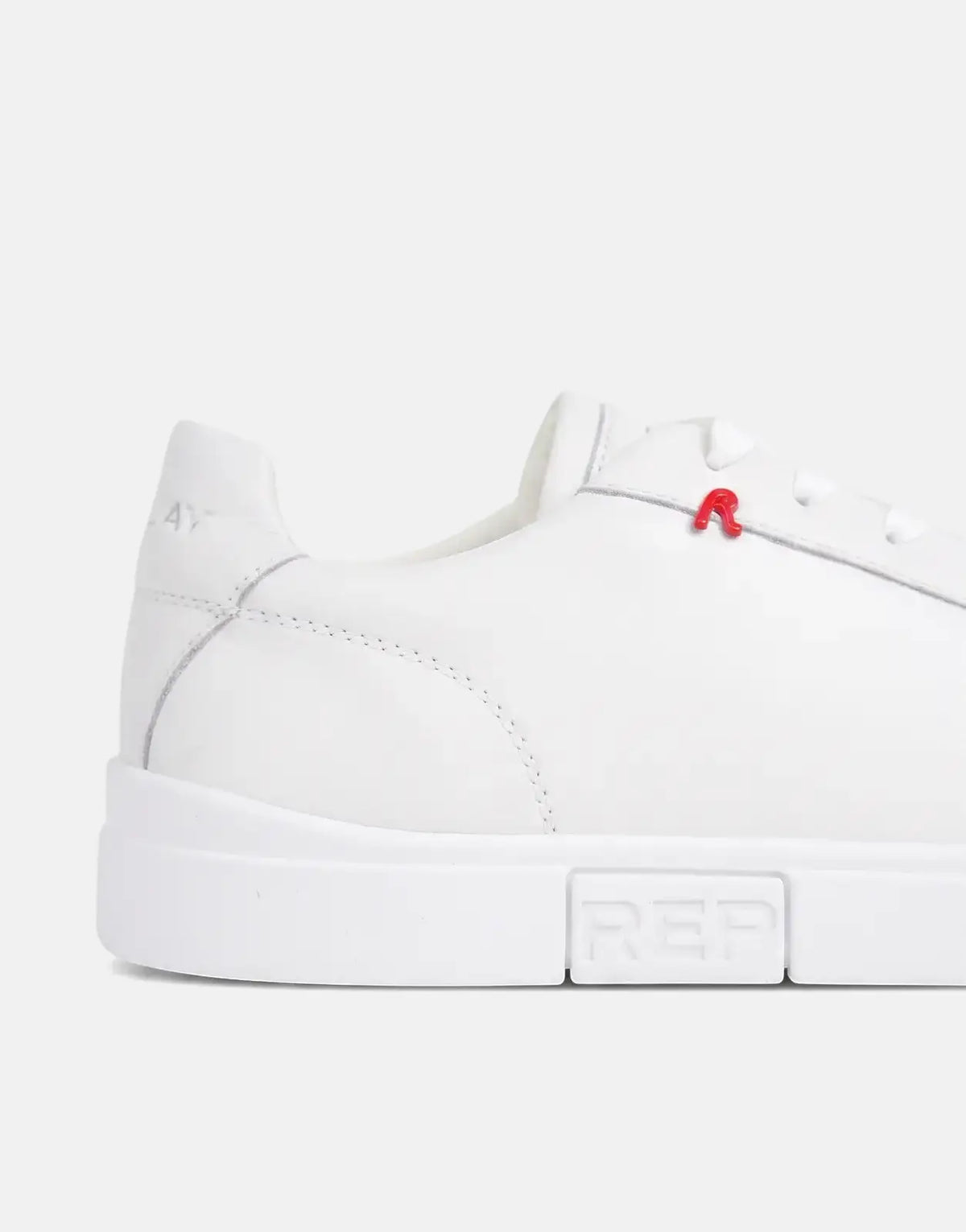 Close-up side view of a white leather Replay Poly R SA sneaker with a red R logo and 'REP' embossed on the sole.